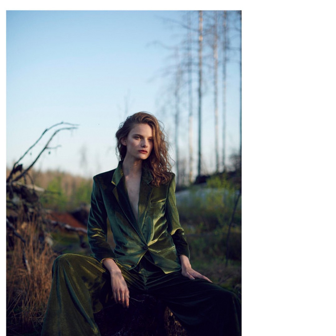 Green velvet Marcelo suit photographed among bare trees in Sweden